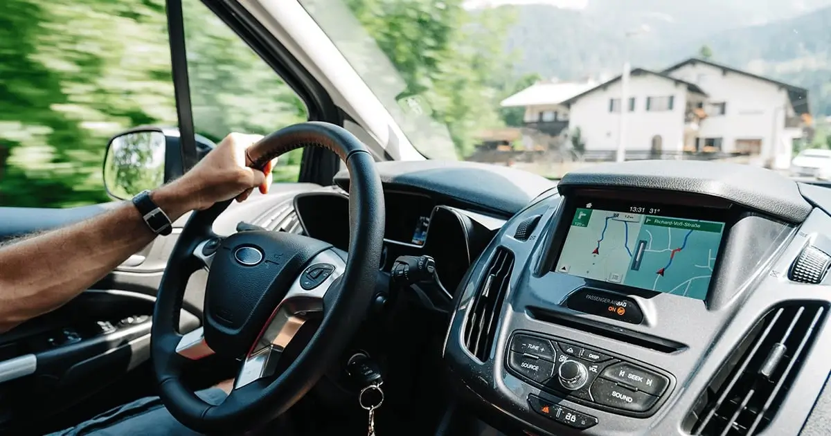 Rideshare driver driving and navigating via GPS inside a car