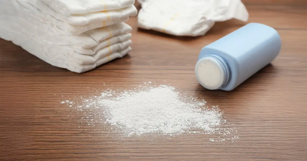Talcum Powder on table next to diapers